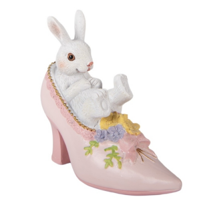 Rózsaszín cipőben csücsülő fehér nyuszi